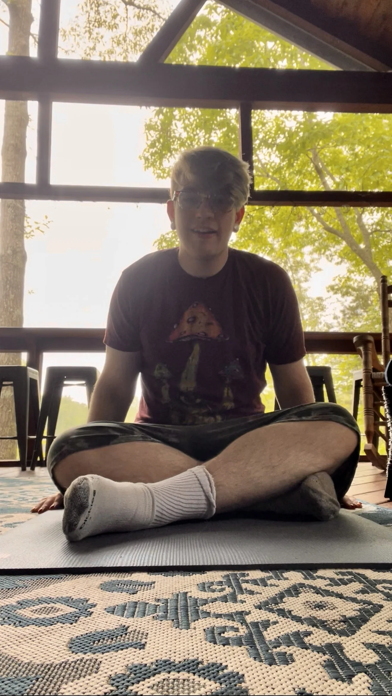 Drew seated in soft porch light before practice.